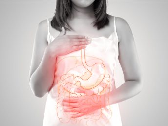 Illustration of internal organs is on the woman's body against a gray background. A Woman touching stomach painful suffering from enteritis.