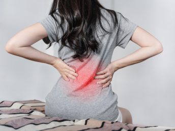 young-woman-suffering-from-back-pain-bed-after-waking-up